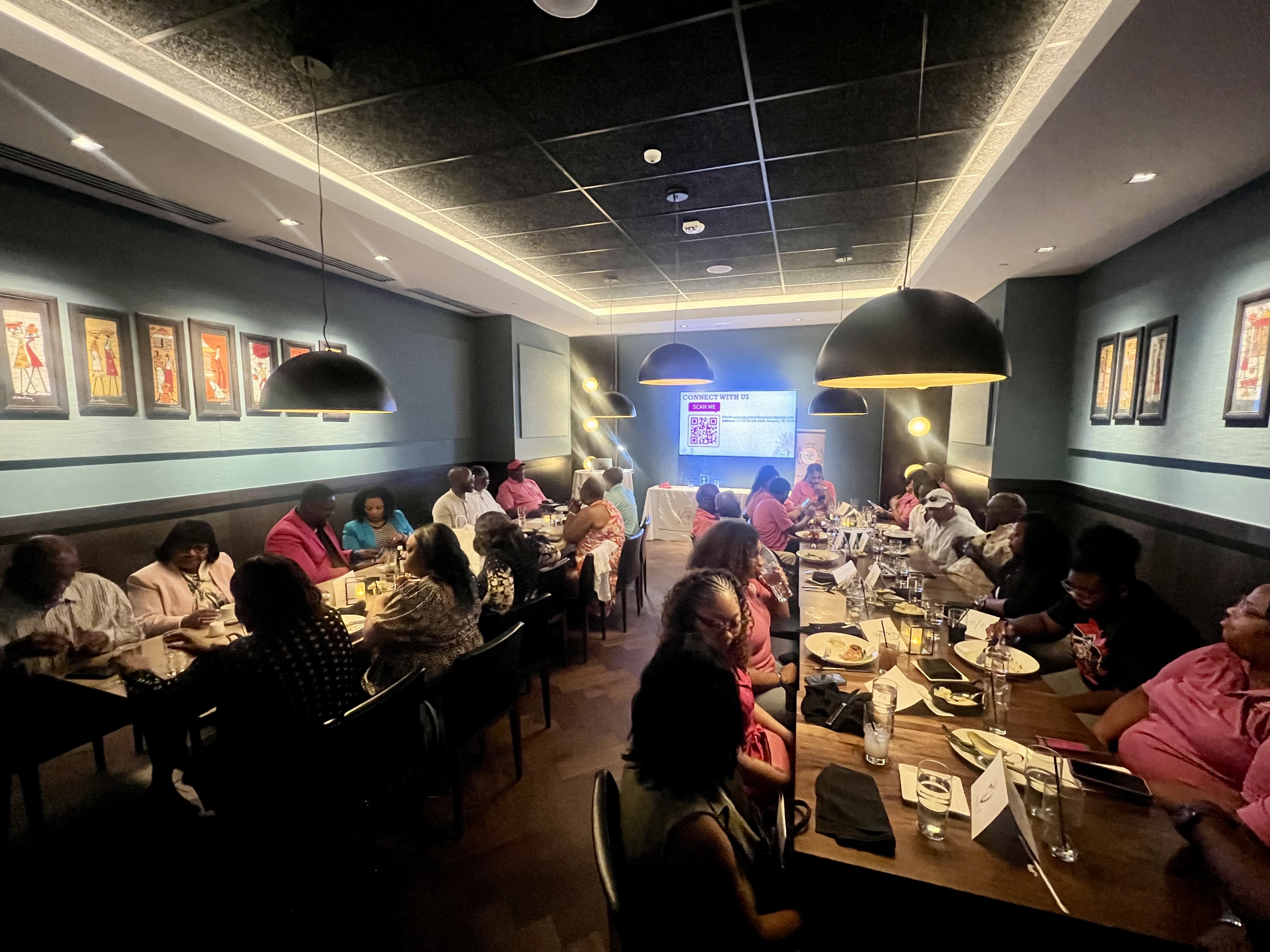 Conference attendees enjoying dinner and presentations
